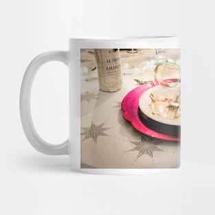 : An empty plate with only a little leftover crumbs, the empty wine glass has fallen over Mug